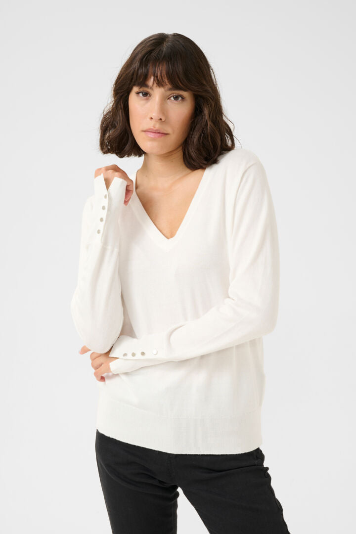 Pull avec boutons aux poignets